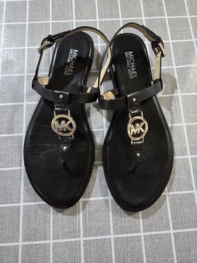 Michael Kors Black Leather T-Strap Sandals with Gold MK Medallions
